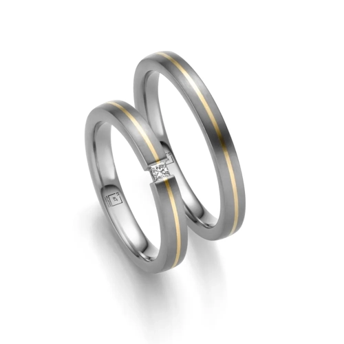 alianzas de boda de tántalo y oro amarillo con un diamante princesa
