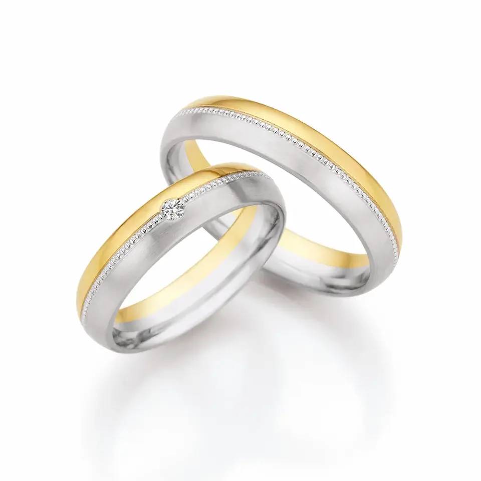 Alianzas de boda de oro amarillo y paladio con diamante