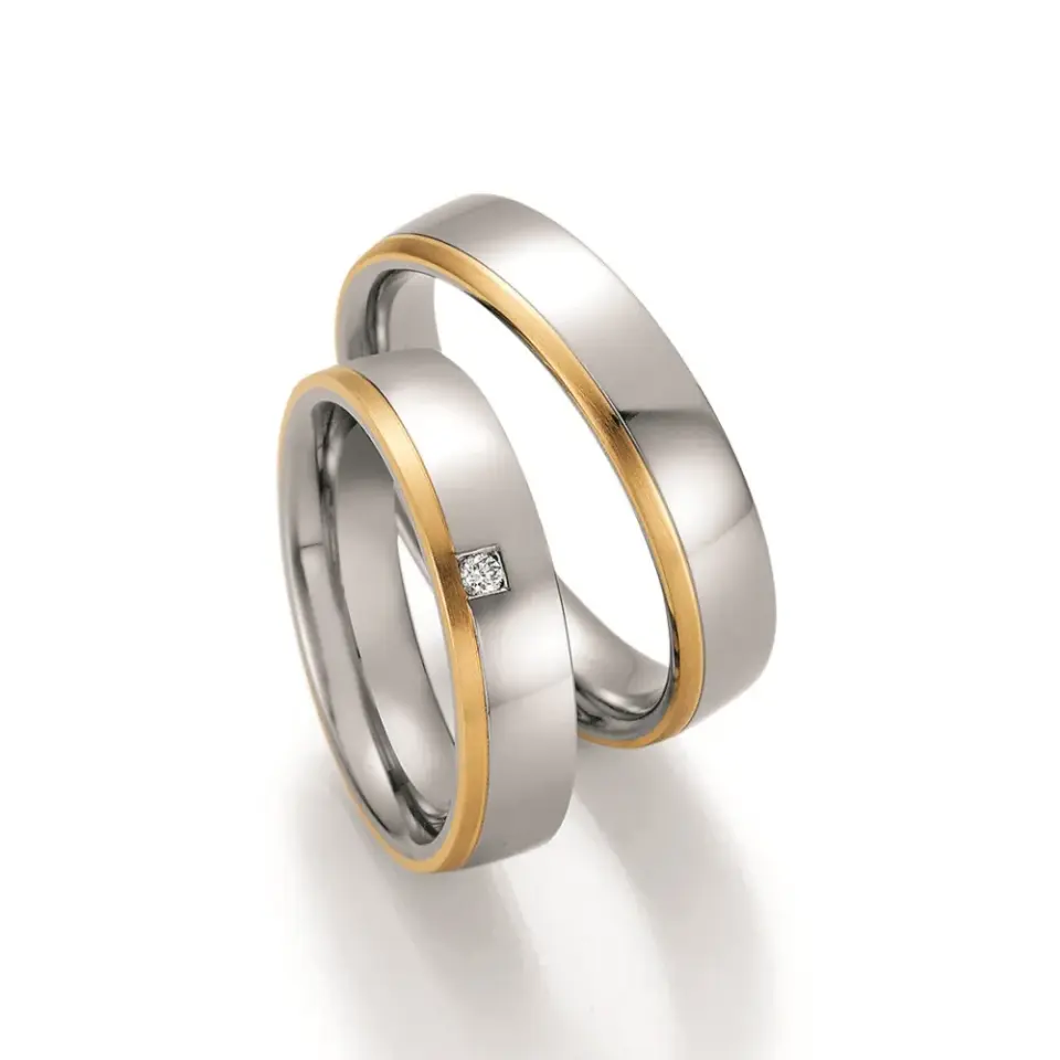 Alianzas de boda de acero y oro amarillo con diamante