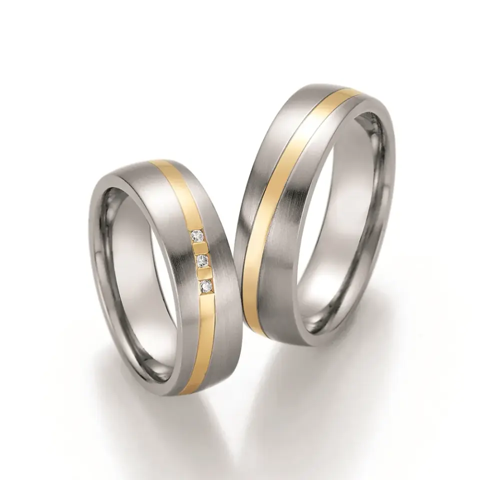 Alianzas de boda de acero y oro amarillo con diamantes