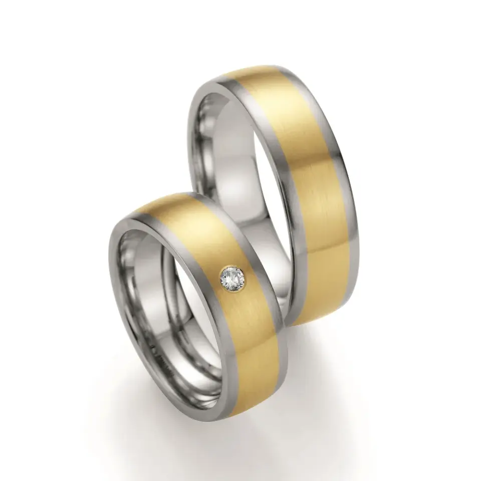 Alianzas de boda de acero y oro amarillo con diamante