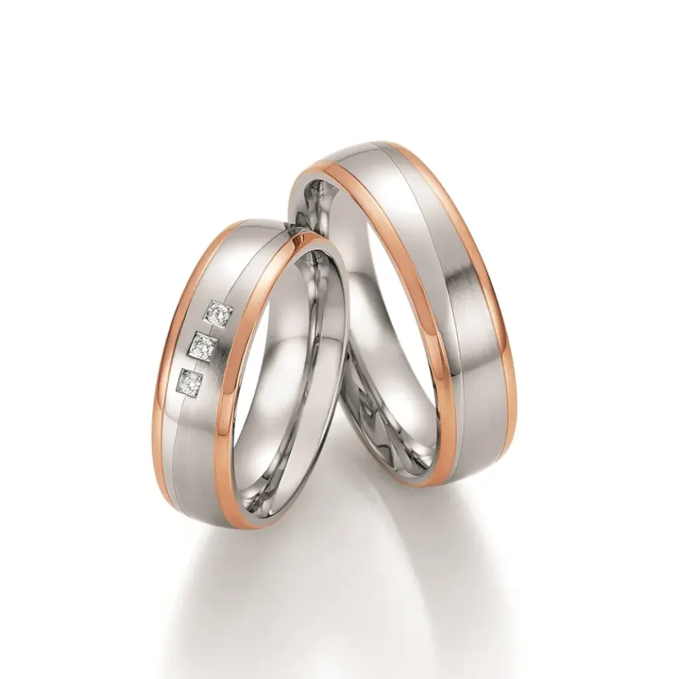 Alianzas de boda de acero y oro rosado con diamantes