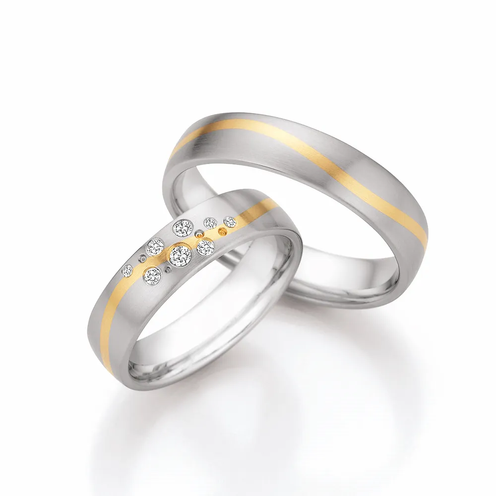 Alianzas de boda de acero y oro amarillo con diamantes